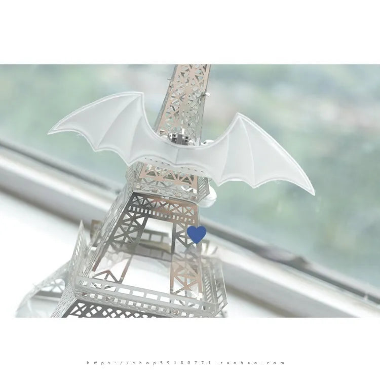 Split Home black patent leather choker collar with large silver wings and a central bell on a model.