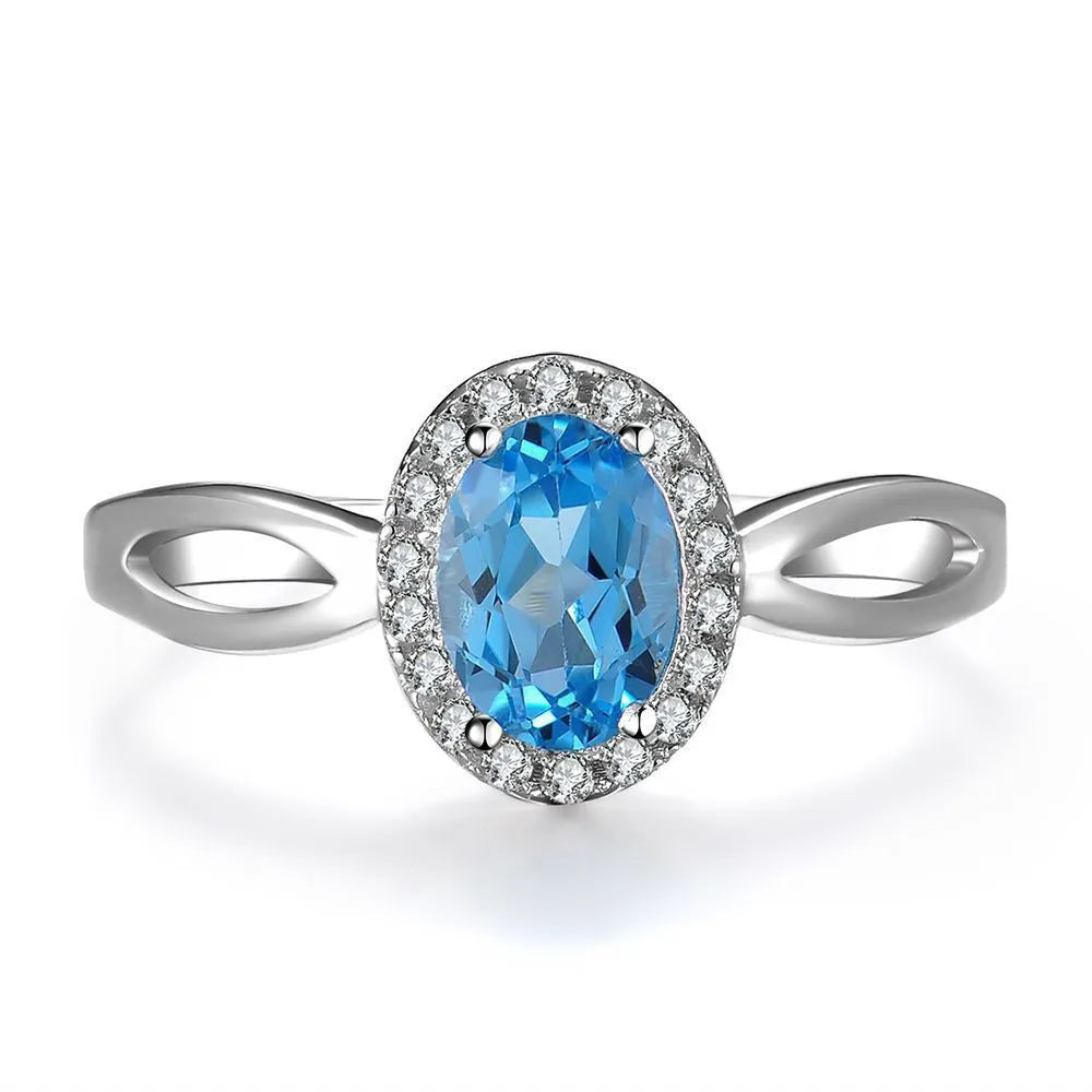 925 sterling silver blue topaz jewellery set showing necklace, ring, earrings and pendant with geometric design