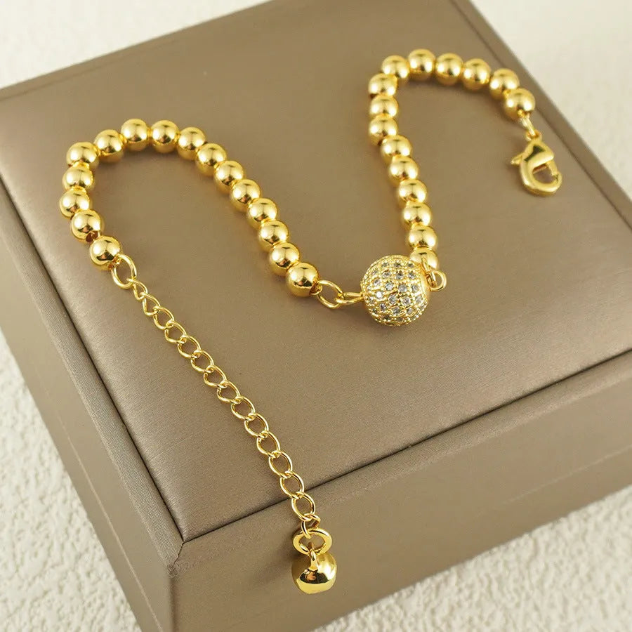 Close-up of a women's copper heart bracelet with a round zircon stone in an Arabic style.