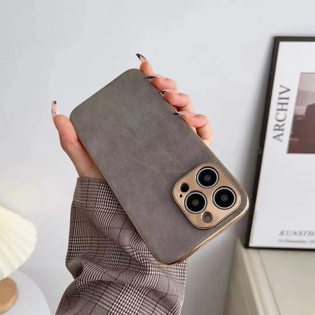 Leather-textured TPU phone case for iPhone on a table, showing colour and precise button cutouts.