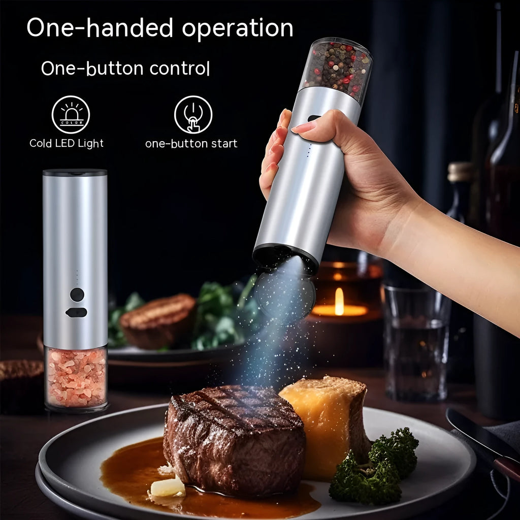 White electric salt and pepper grinder set with clear glass jar and stainless steel top on kitchen counter