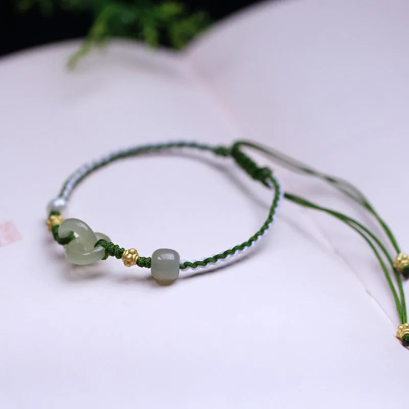 DIY woven bracelet with Hetian jade beads and silver or gold plated metal accents on a flexible wire band.