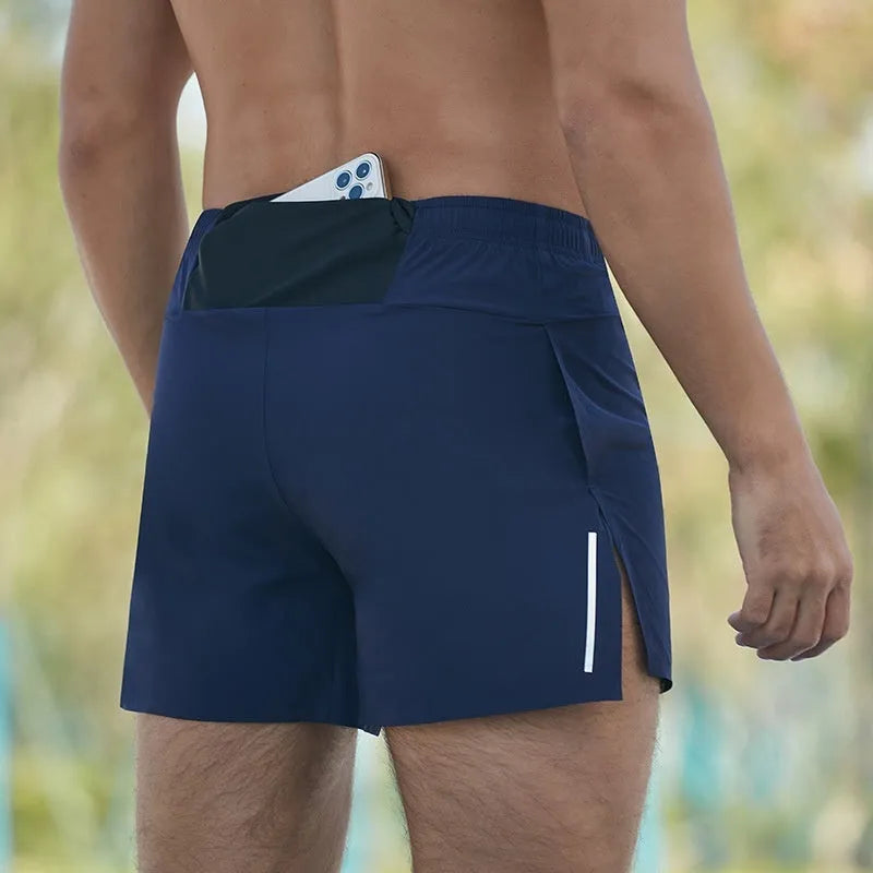 Man wearing high-waisted grey off-road running shorts, showing loose fit and athletic design.