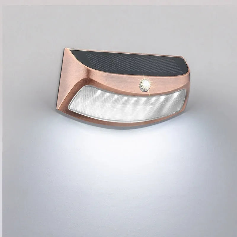 Solar-powered smiling face outdoor wall lamp with warm or white light options.
