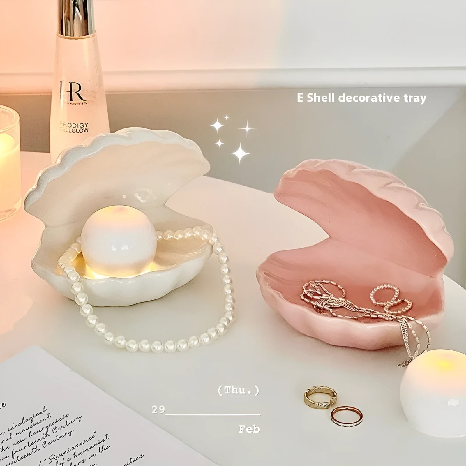 White porcelain decorative storage tray with a small built-in night light, holding jewellery on a bedside table