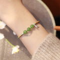 Handmade woven Hetian jade bracelet with diamond shape and lotus seedpod design in light green or blue chalcedony