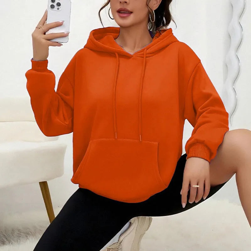 Women's loose grey sweatshirt with a drawstring hem and side pockets, laid flat.
