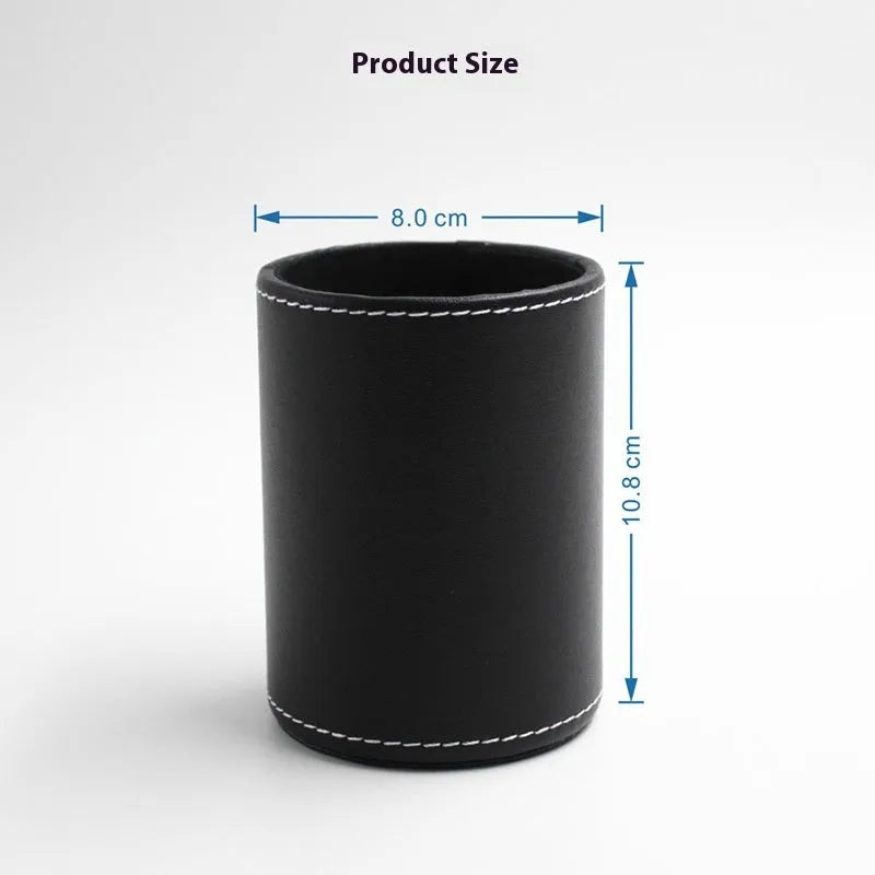 Round black leather pen container on a desk holding pens and pencils.