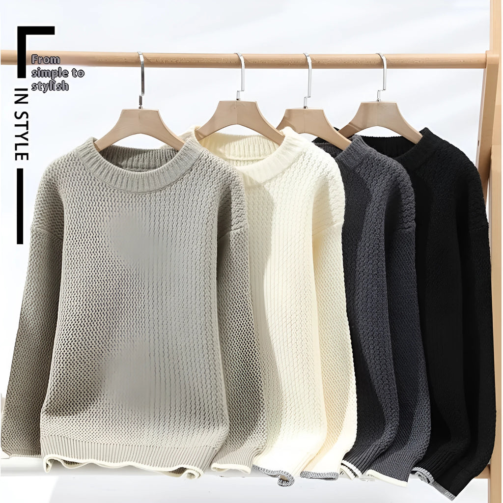 Man wearing a grey loose-fit round neck men's pullover sweater.