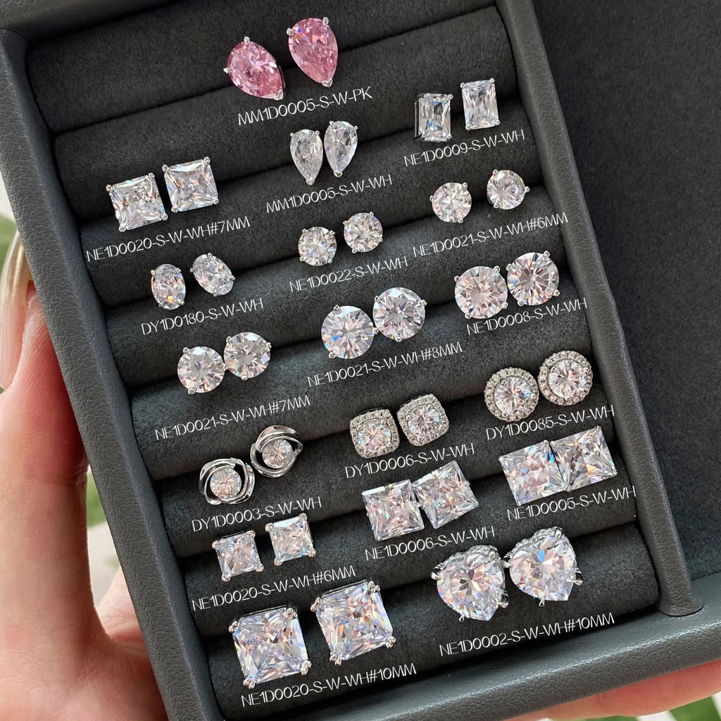 Pair of sterling silver geometric stud earrings with heart and square shapes