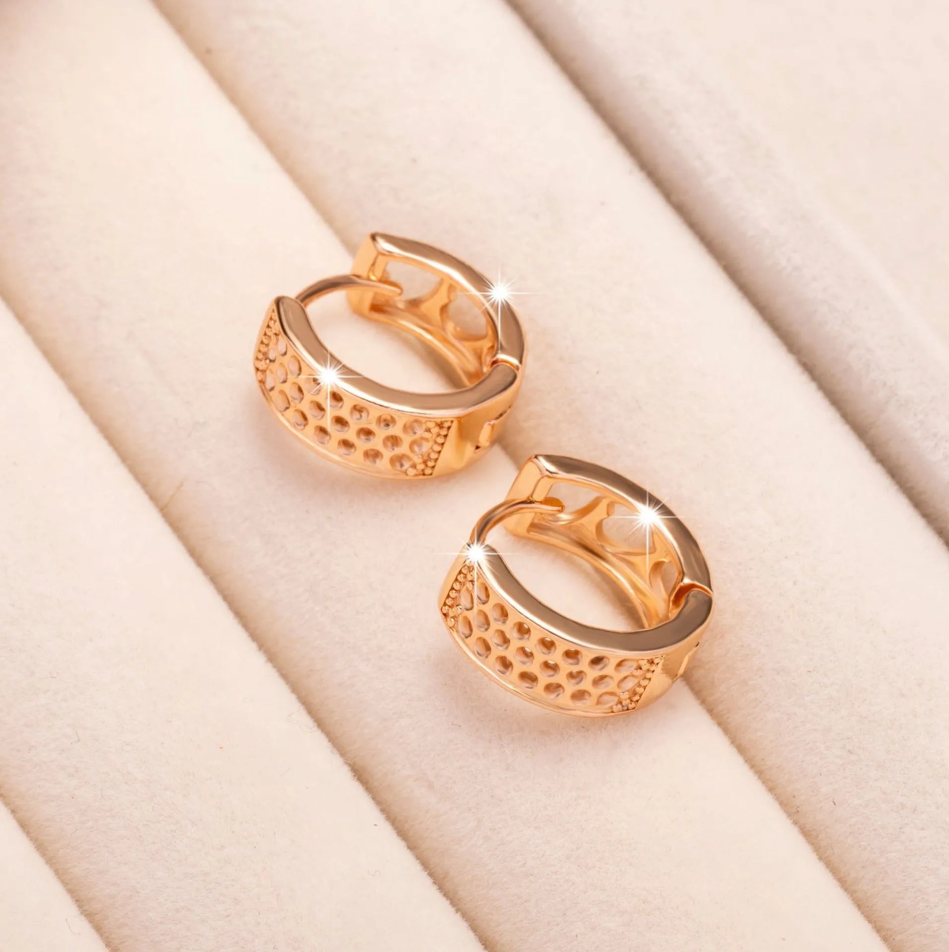 Rose gold women's earrings with a hollow heart shape featuring three cut-out sections.