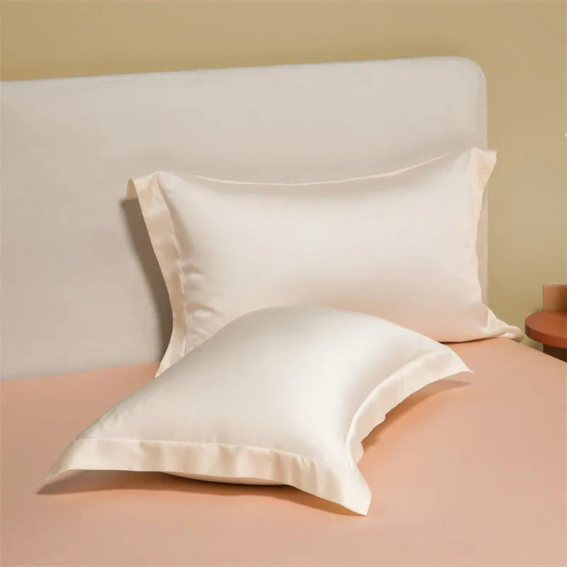 Luxury Lenzing Tencel quilt cover and pillowcases in Aurora Blue on a bed, showing satin weave texture.