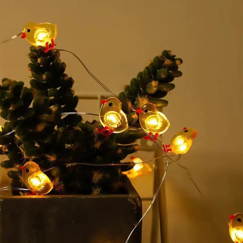 Easter carrot and rabbit shaped battery-operated LED decorative string lights on a dark background.