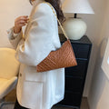 Brown pleated PU baguette shoulder bag with a top handle and long chain strap on a white background.