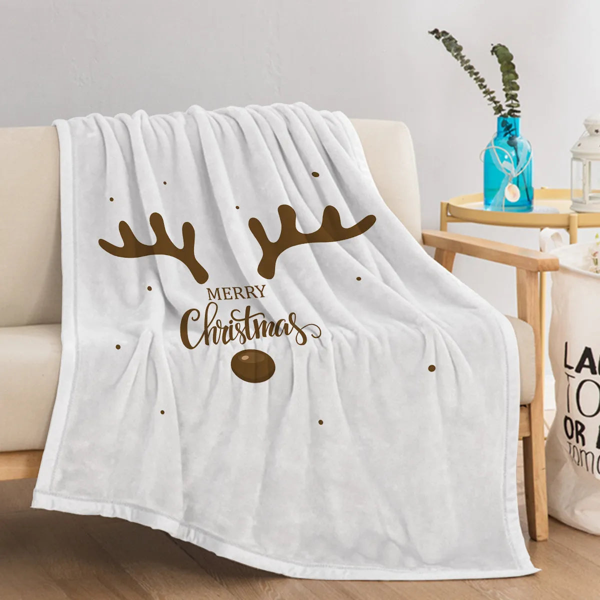 Deer antler pattern Christmas limited edition white flannel velvet blanket on a sofa
