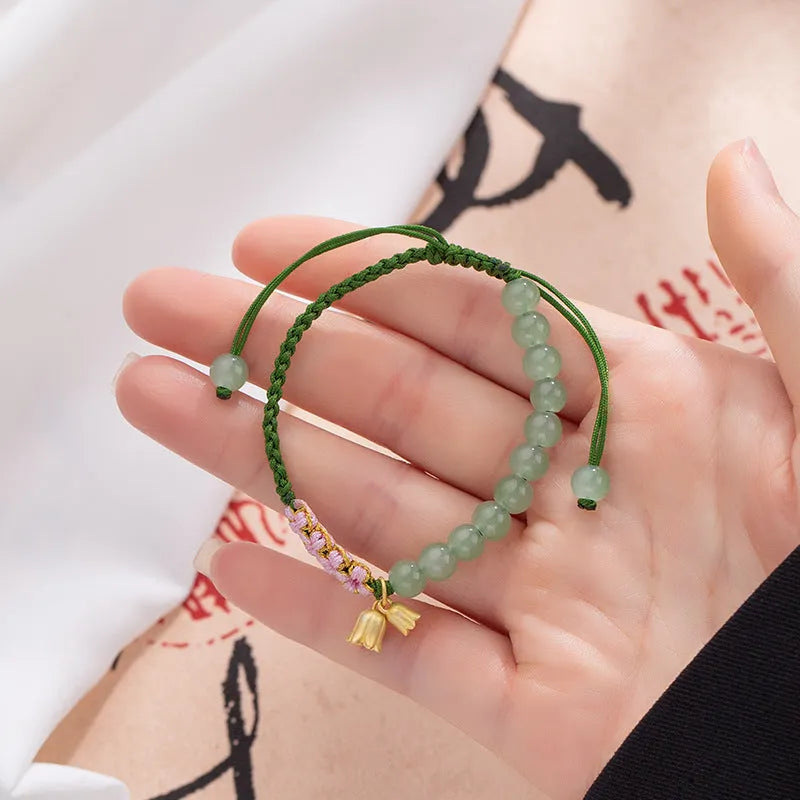 Hand woven red rope bracelet for women with lily carrying strap design and flower pattern