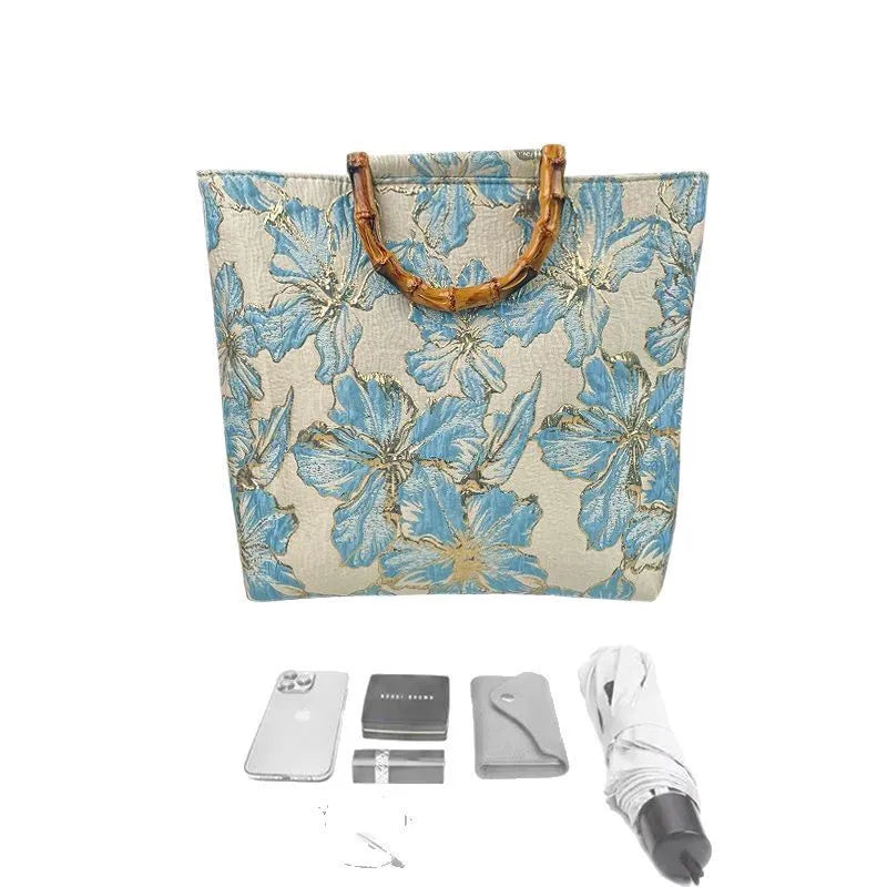Light blue canvas shoulder bag with gold floral pattern showing 30x30x10 cm dimensions and double straps