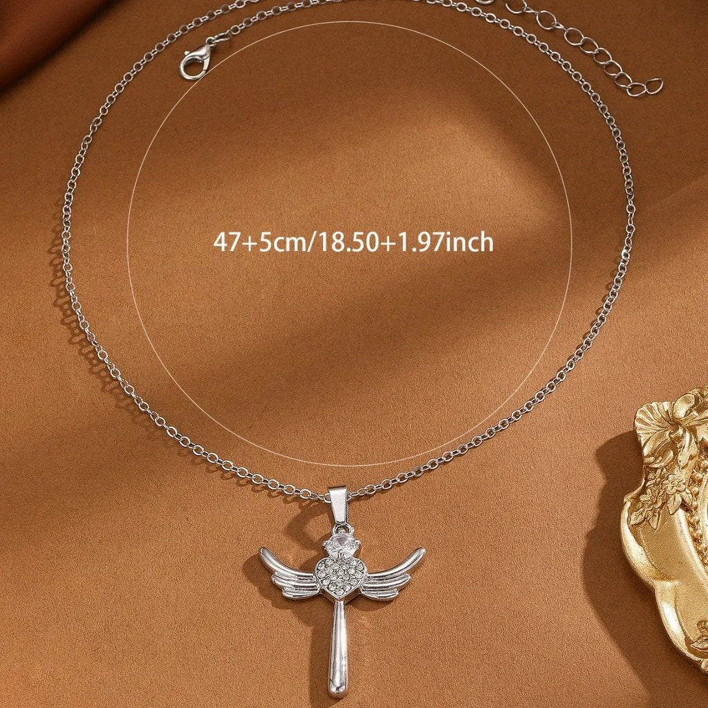 Silver heart-shaped angel wings pendant clavicle chain necklace with cross elements on display