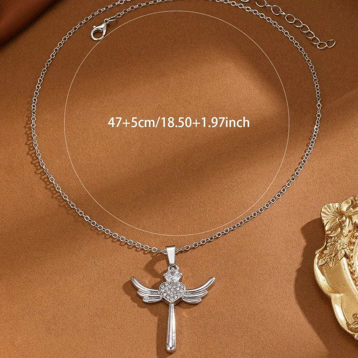 Silver heart-shaped angel wings pendant clavicle chain necklace with cross elements on display