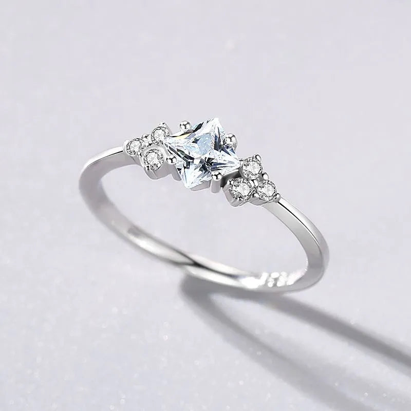 S925 silver ring with geometric rhombus shape and gold-plated setting on a plain background