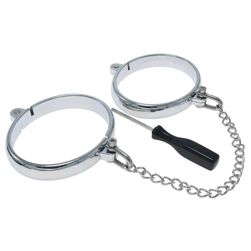 Silver zinc alloy handcuffs and footcuffs set for adults on a dark background