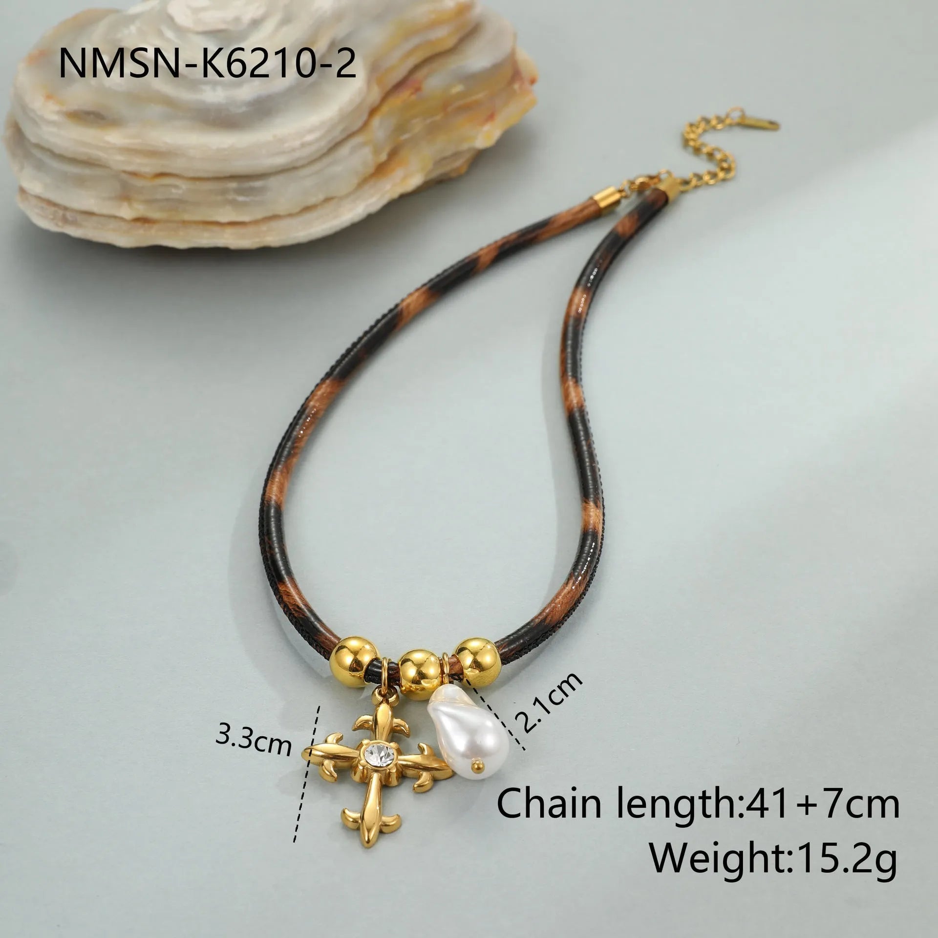 Geometric stainless steel necklace with leopard leather accents on pendant and gold-plated chain