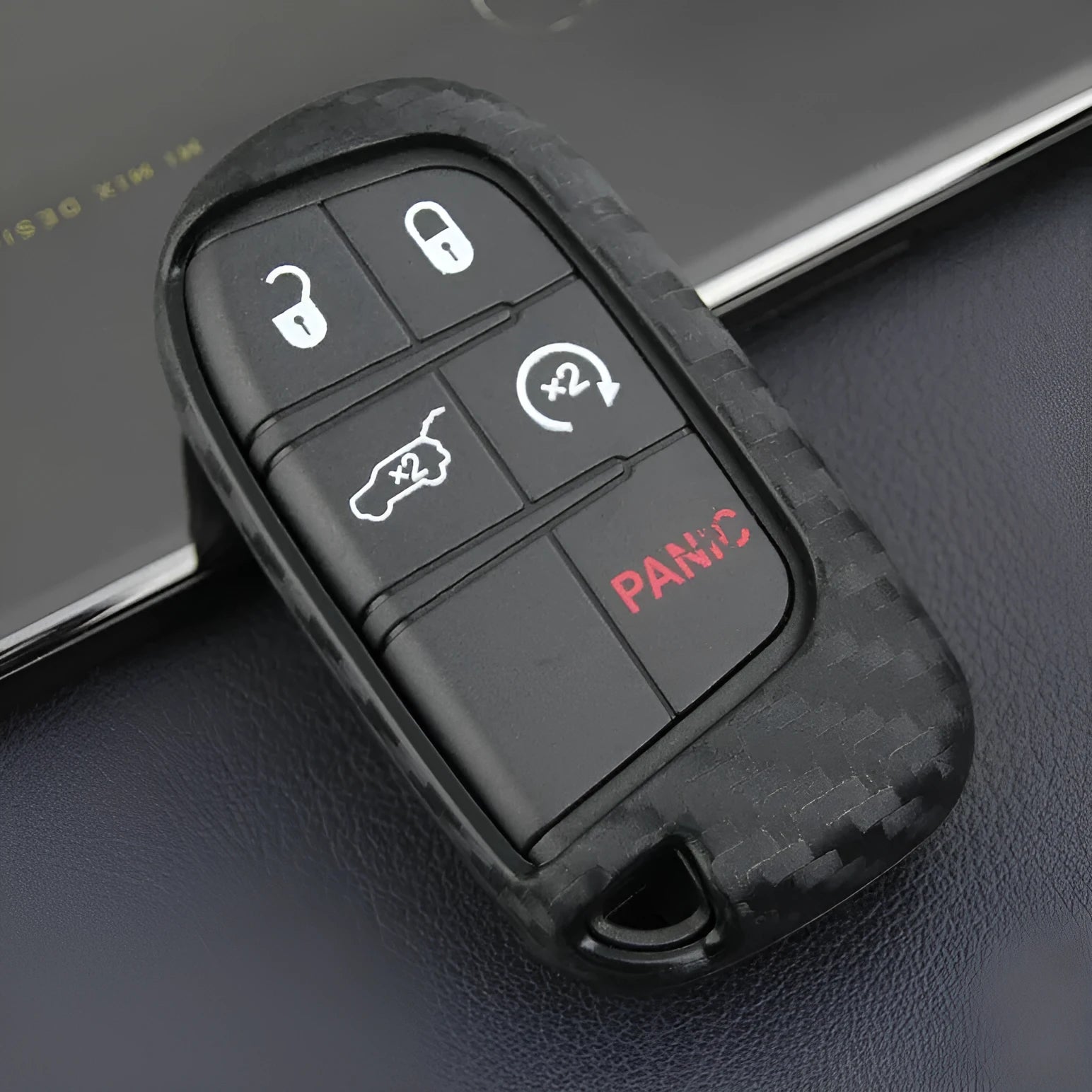 Carbon fibre pattern silicone protective case for a Dodge, Chrysler, or Fiat car key remote with a large head buckle.