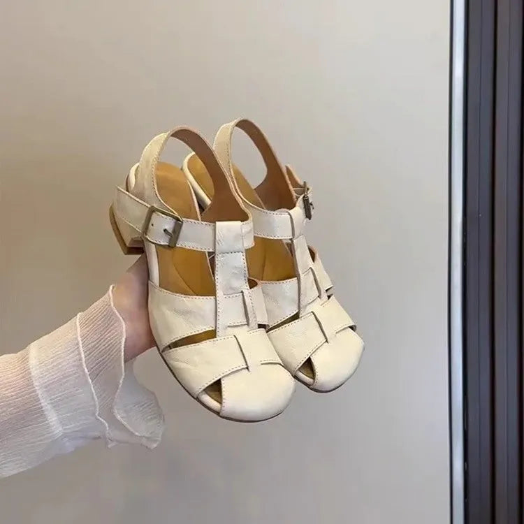 Women's woven Roman shoes with round toe and buckle in apricot and black colours on display