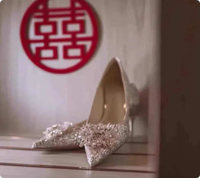 Champagne coloured pointed toe bridal shoes with rhinestone floral pattern on a fine heel.