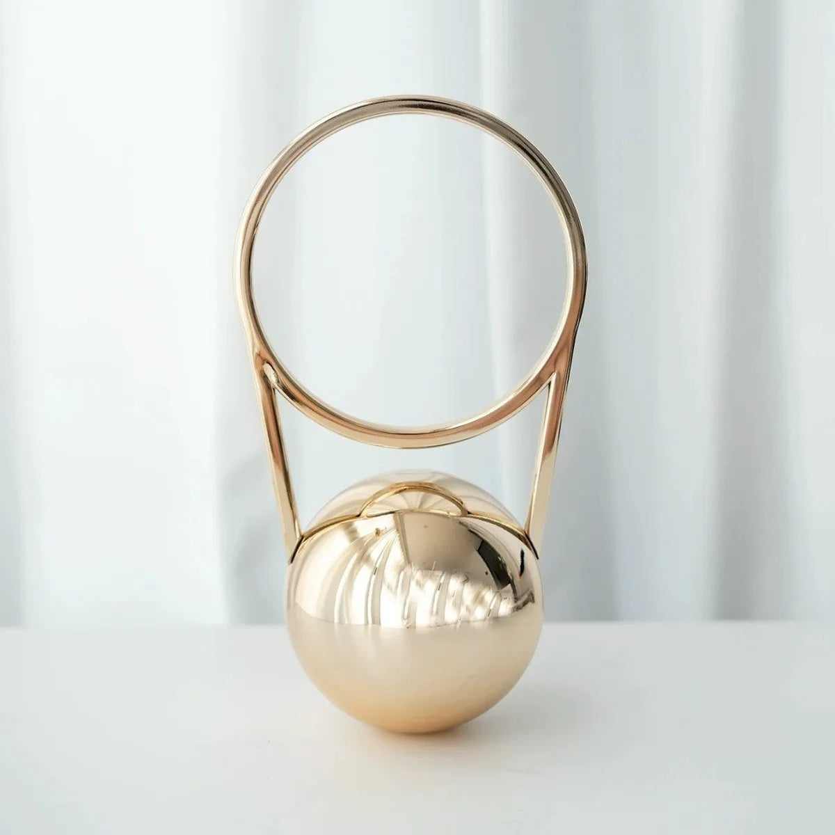 Round PVC dinner bag with electroplating handle and stitching detail in gold, measuring 25x11x15cm