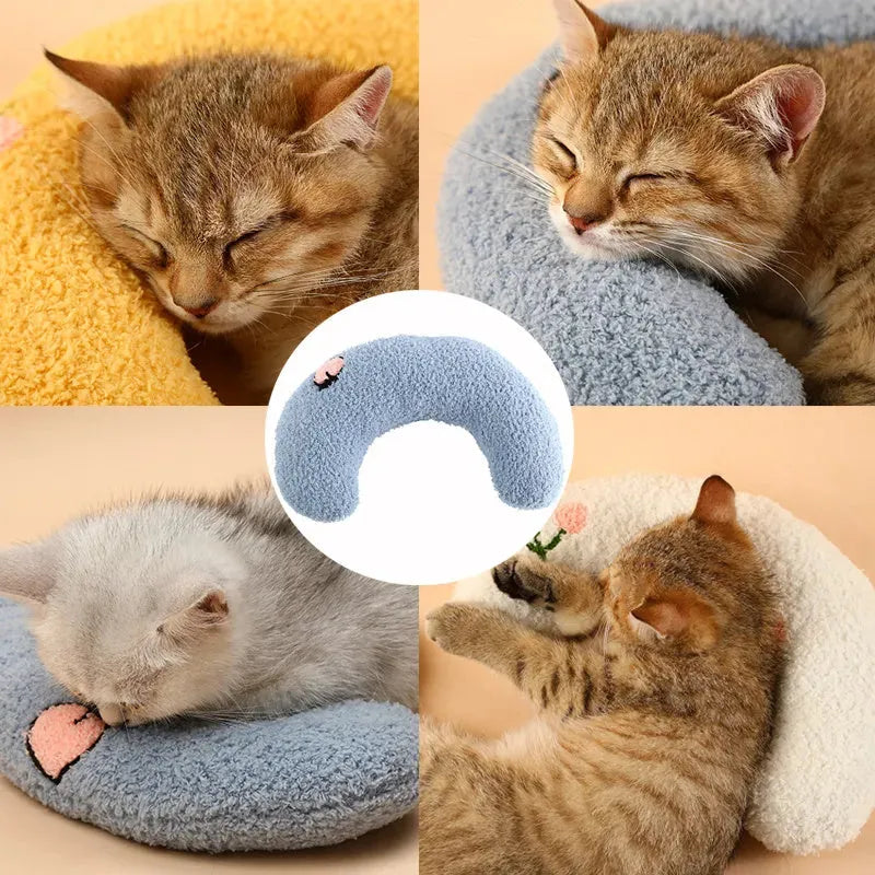 Small U-shaped plush pet pillow in blue for cats and small dogs on a white background.