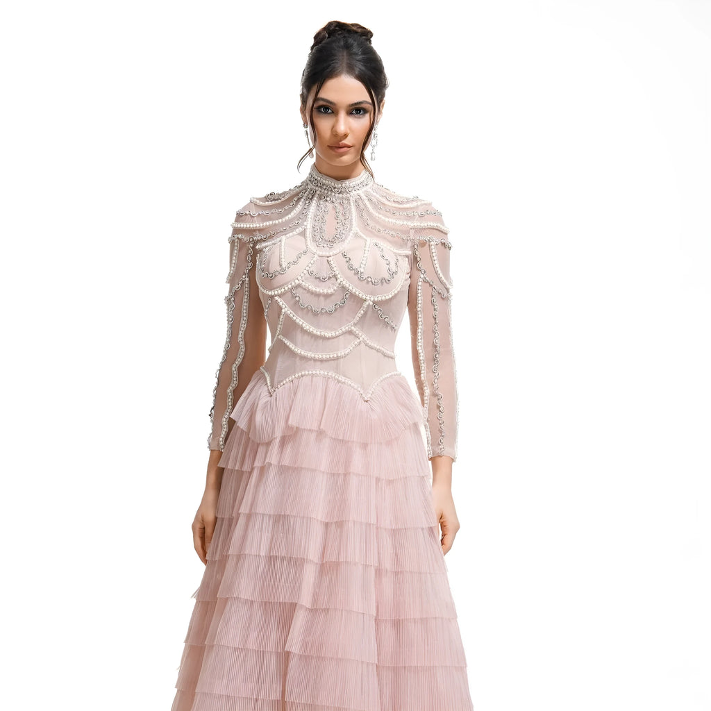 Women's black long sleeve beaded dress with a mid waist and long skirt.