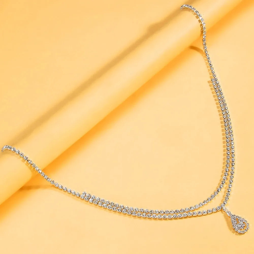 Gold or silver women's waist chain with rhinestone drop pendant and tassel, 105cm long.