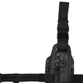 Tactical leg holster with waist plate and quick-pull plastic construction in outdoor setting