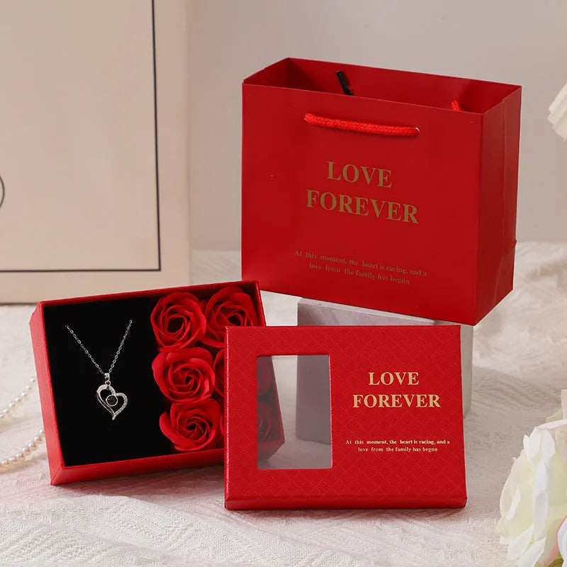 Six red soap roses in a black Korean-style gift box with a matching handbag