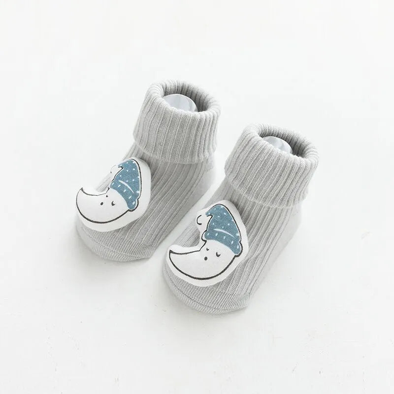 Pair of light grey baby socks with white non-slip silicone grip dots on the soles.