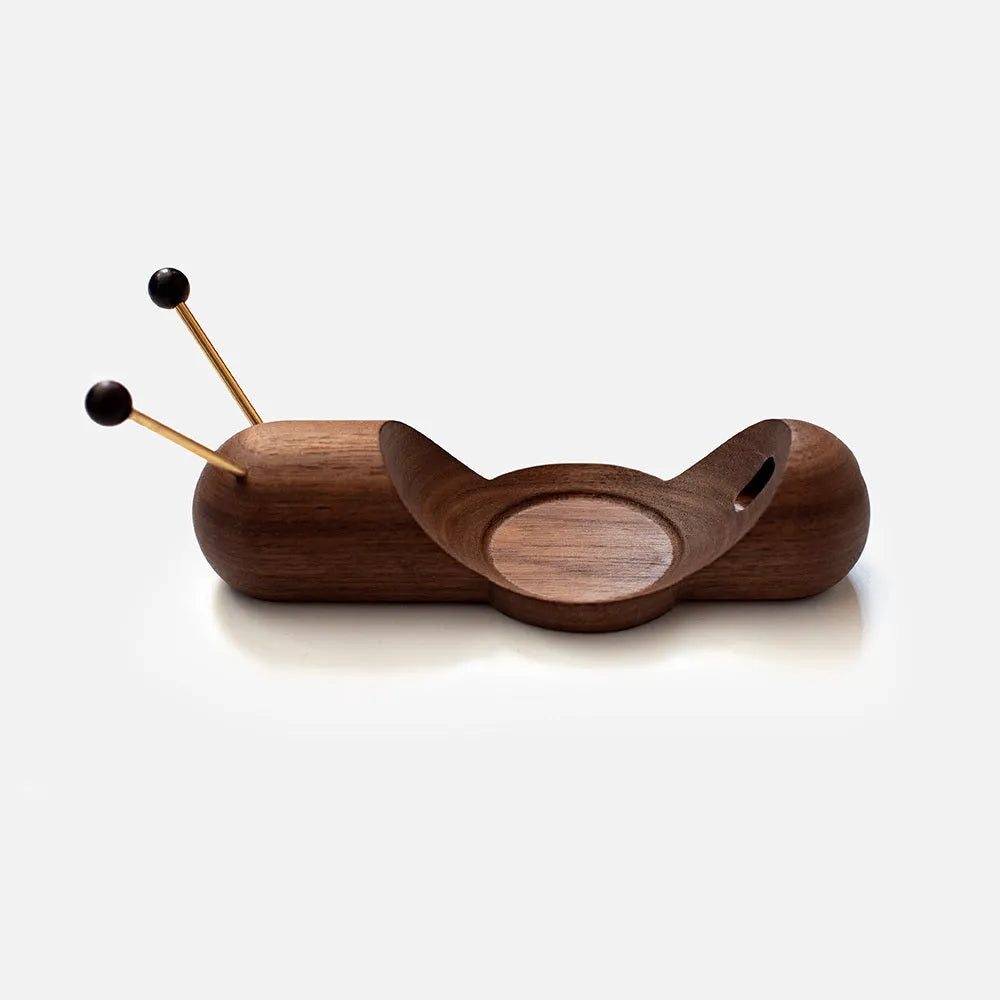 Khaki brown non-slip desktop bracket for holding a HomePod-sized Bluetooth speaker.