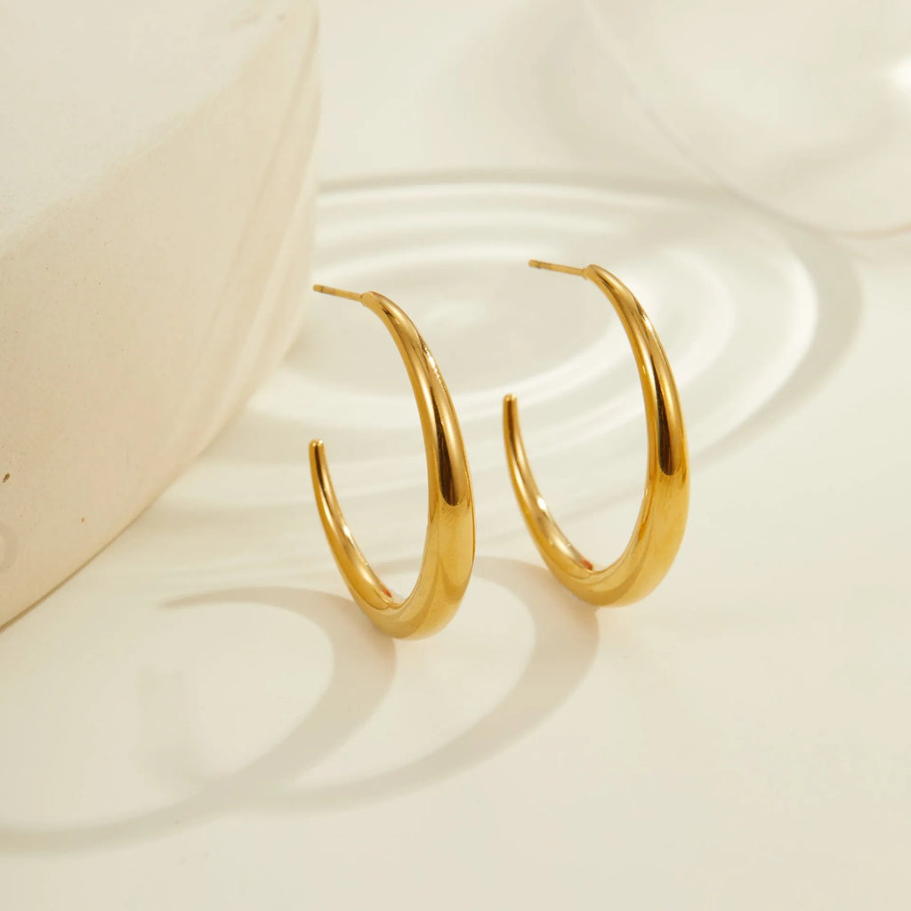 Titanium steel hoop earrings with 18K gold plating in geometric round design