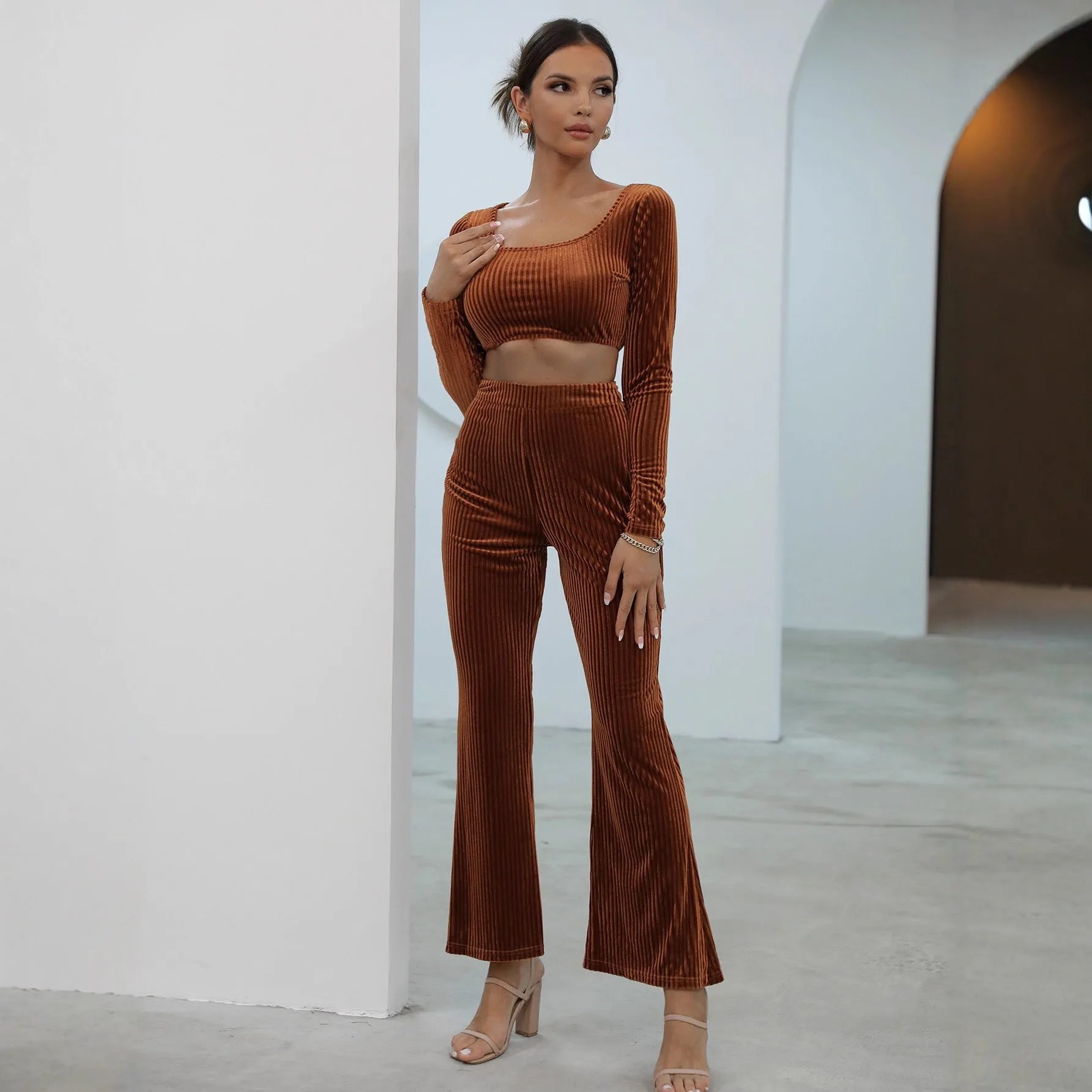 Caramel-coloured women's long sleeve knit sweater and matching trousers laid flat, a two-piece loungewear set.