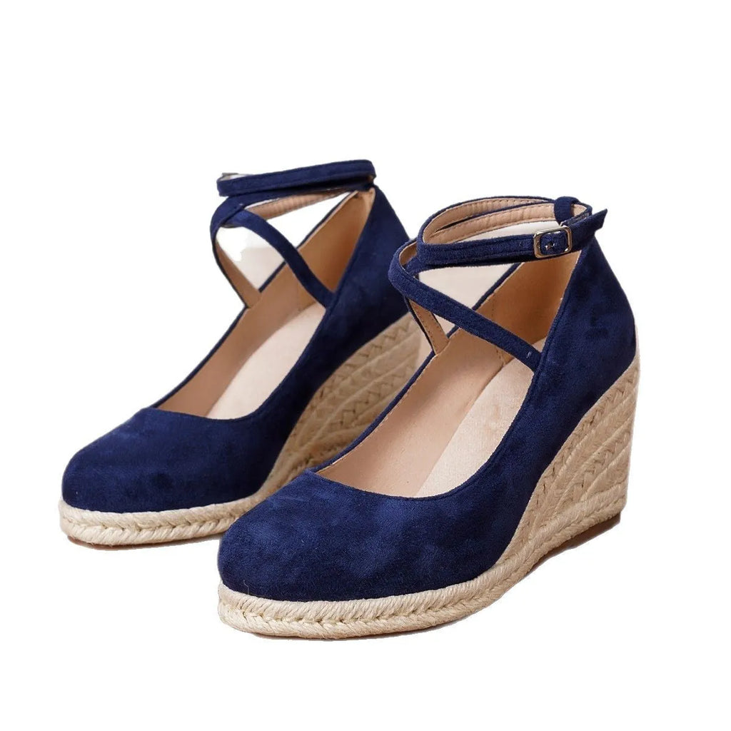 Dark blue suede straw woven wedge closed toe high heels with buckle fastening on a white background