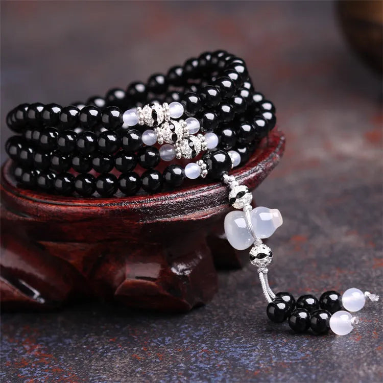 Black and red agate stone bracelet with 108 geometric beads on a wrist