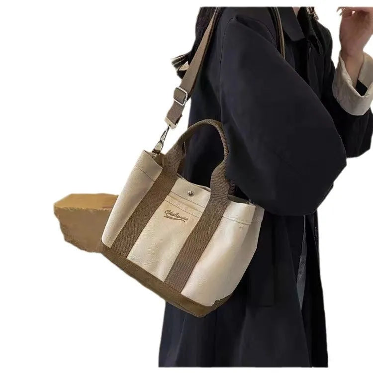 Beige canvas messenger bag with three shoulder straps and sandwich pocket for outdoor and everyday use