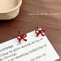 Red bow flocking stud earrings for women with alloy base and electroplated finish, shown as a pair.
