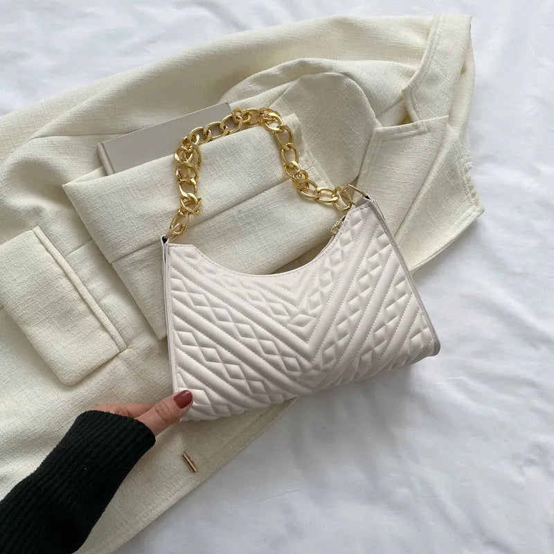Brown pleated PU baguette shoulder bag with a top handle and long chain strap on a white background.