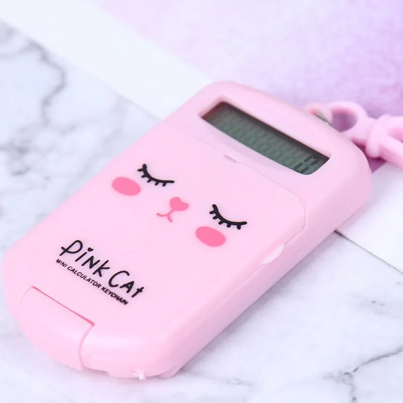 Cookie-shaped mini calculator with key ring in pink, blue, grey, or black, 6.4 x 3.6 x 11.2 cm plastic body
