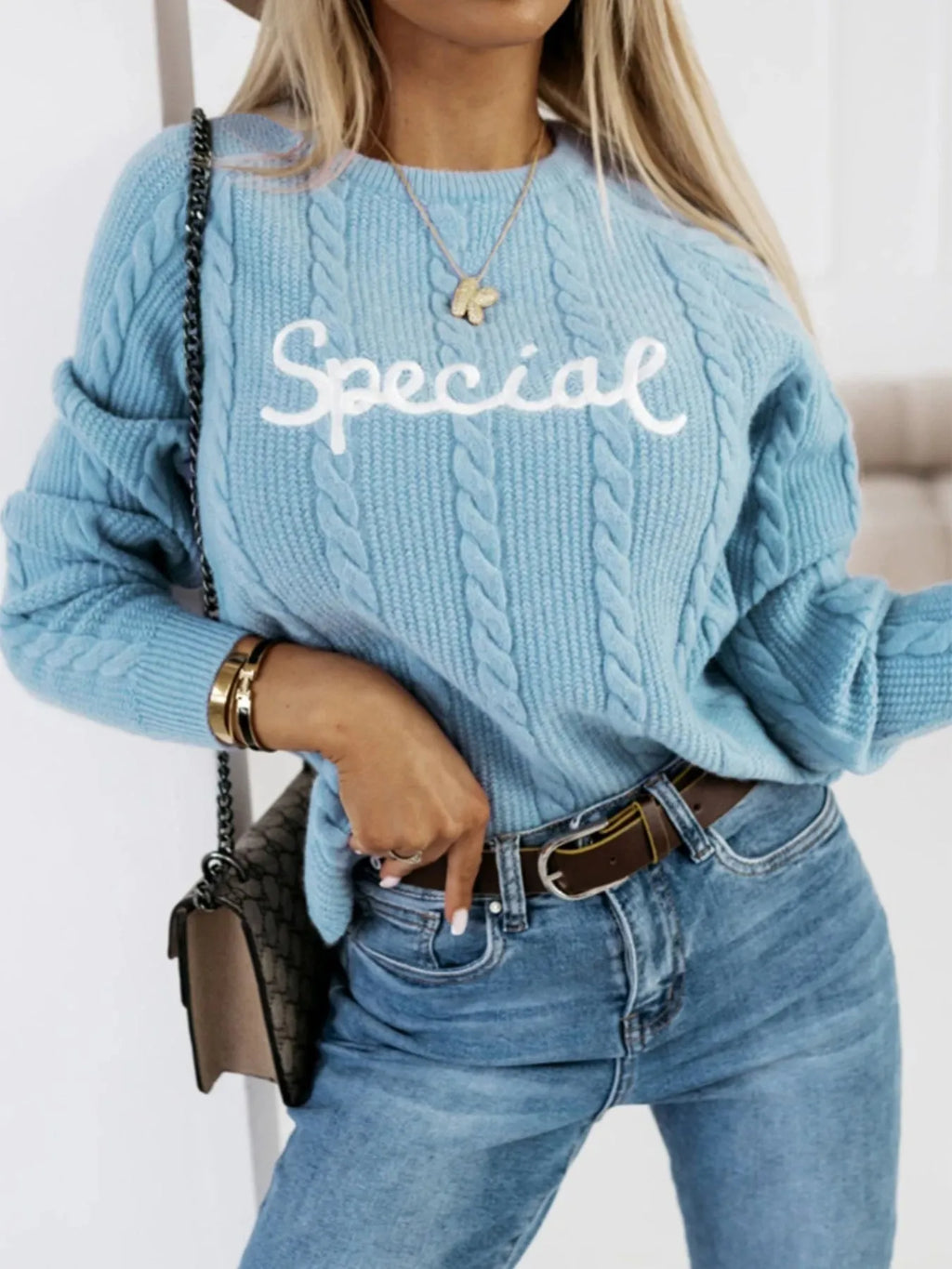 Blue crew neck pullover sweater with white embroidered letters and numbers on the chest