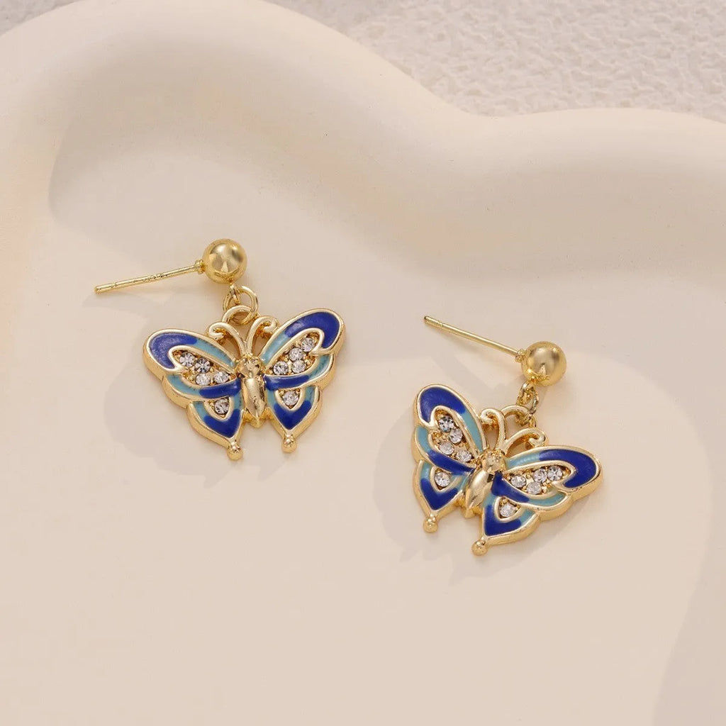 Dripping oil butterfly stud earrings in zinc alloy, classic style, colour O-4-17, on display