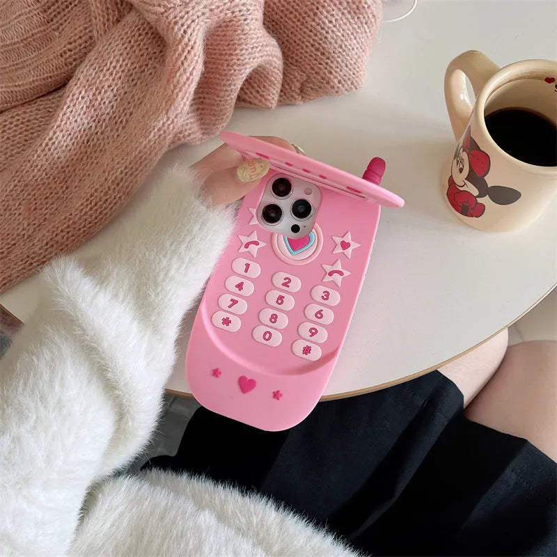 Light pink silicone flip phone case for iPhone with a built-in cosmetic mirror on the front.