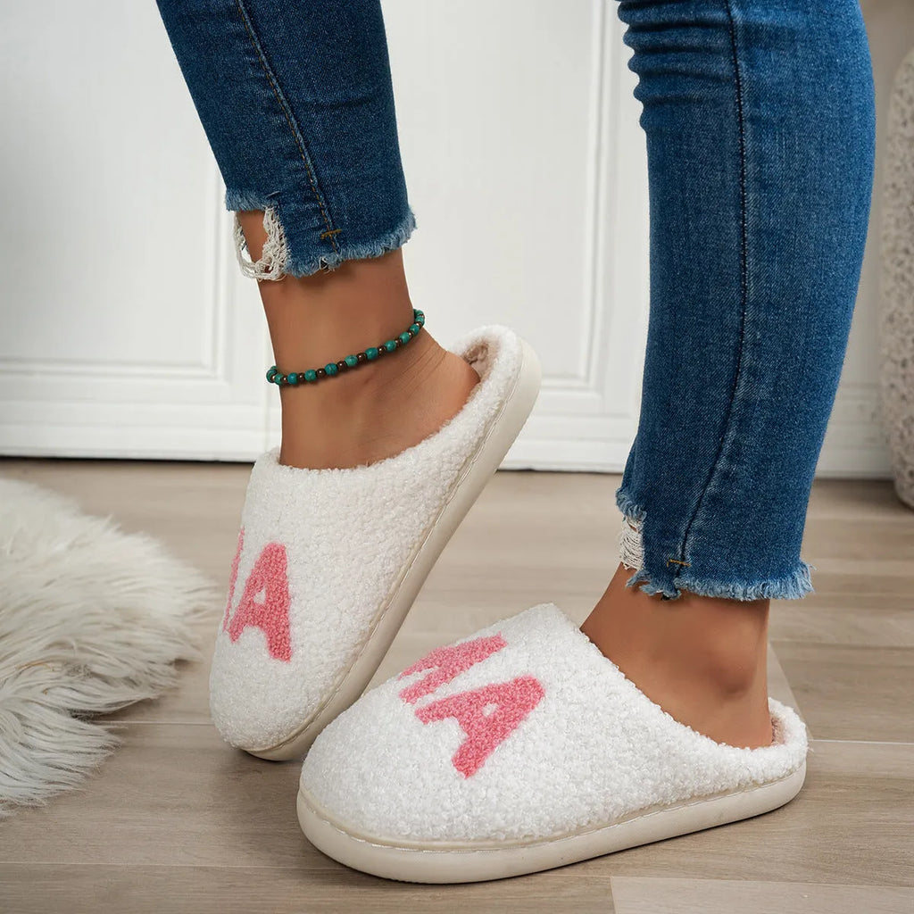 White plush cotton slippers with thick non-slip TPR sole on indoor floor