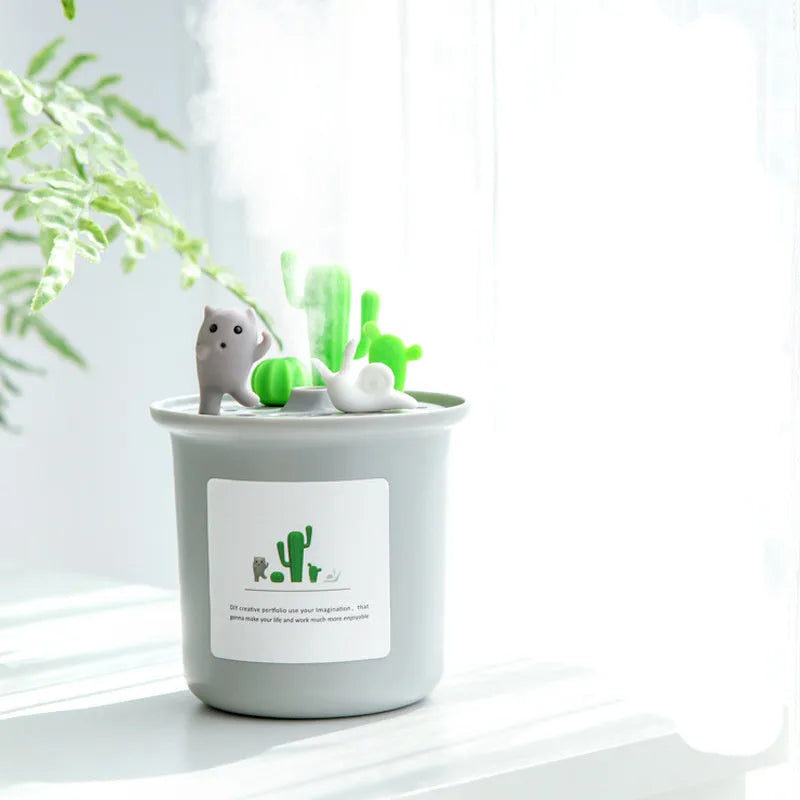 Vase-shaped ultrasonic pet humidifier in cherry blossom pink, with USB cable and water tank.